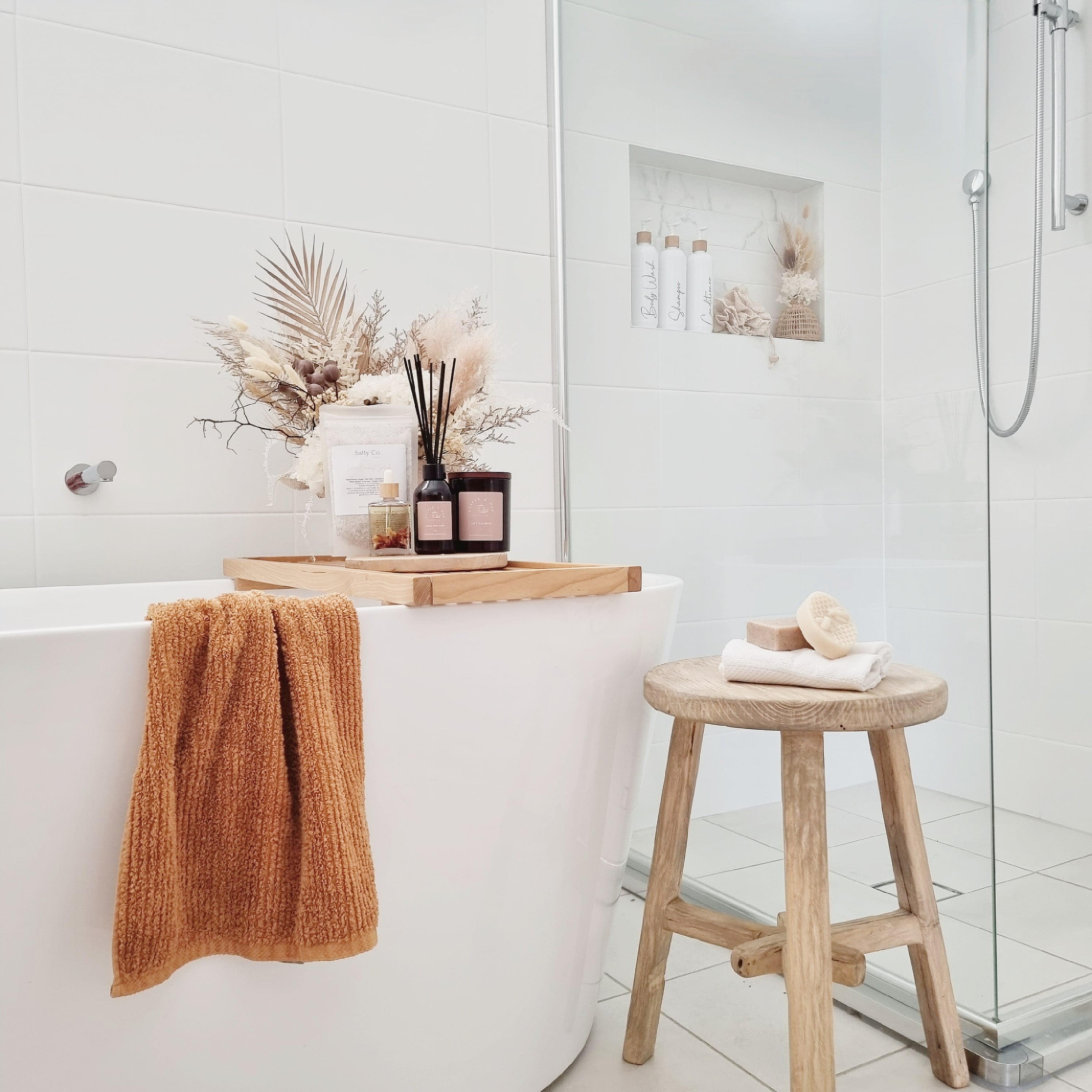 Candle and Reed Diffuser in a clean white bathroom