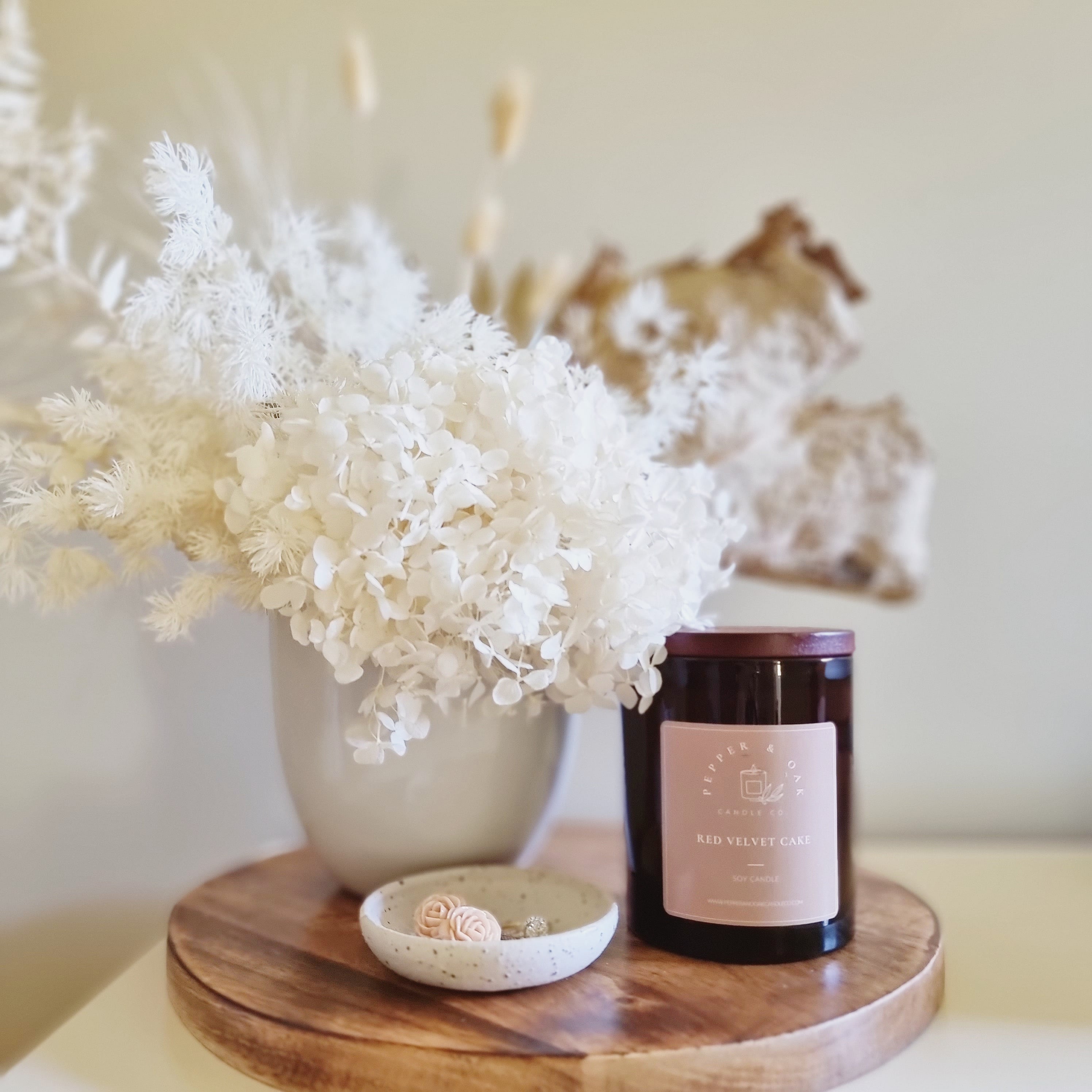 Pepper & Oak Candle on side table